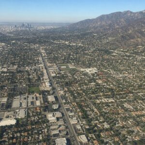 Aerial view of Los Angeles suburbs with mountains and city streets