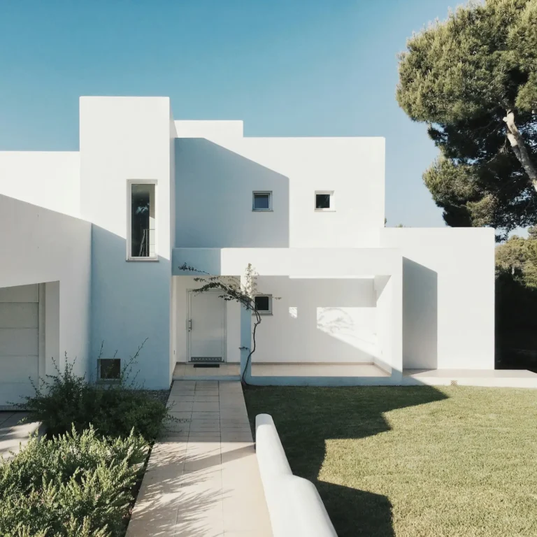 Orange County Property Tax Rate: white modern home exterior with a landscaped front yard